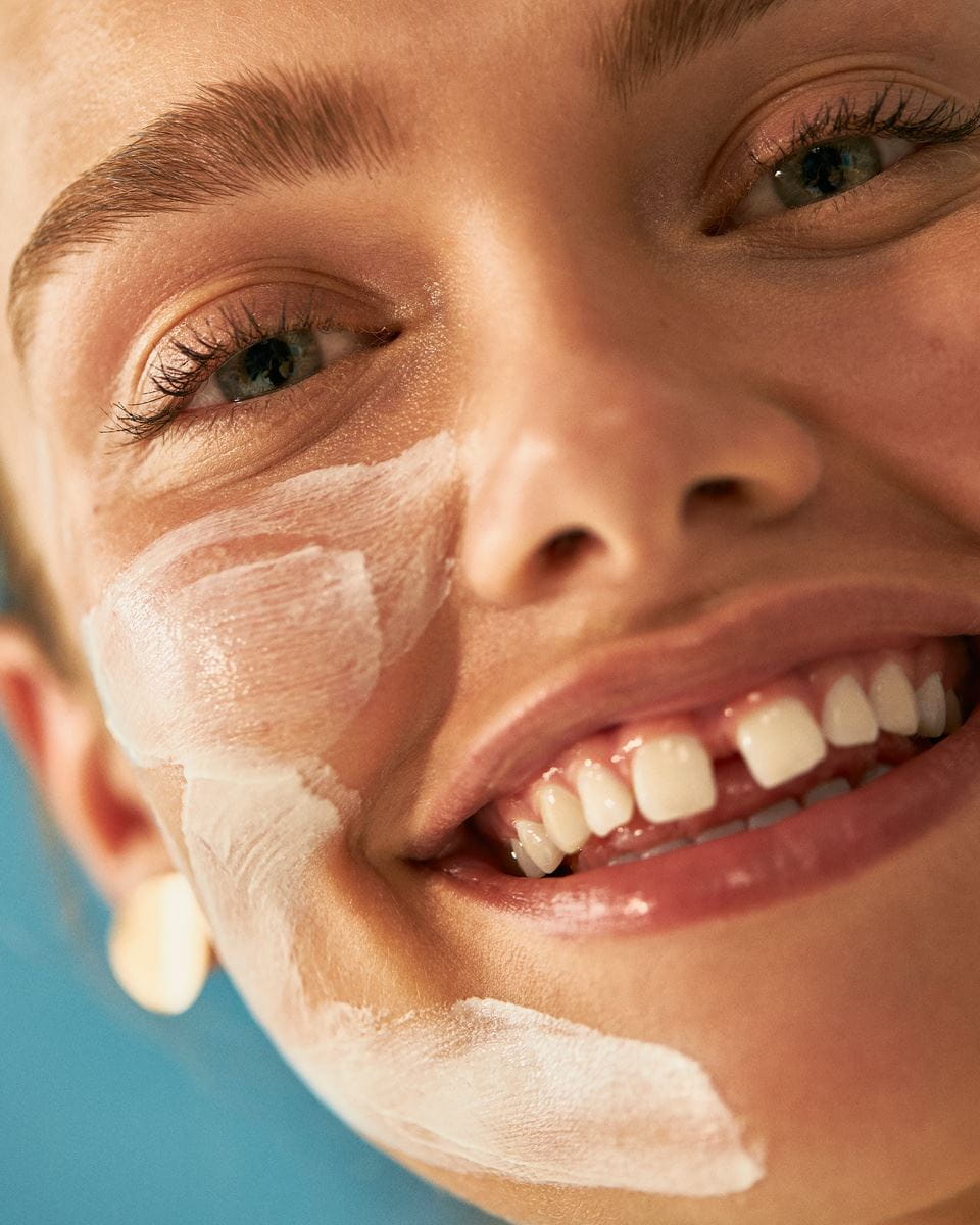 young woman washing her face