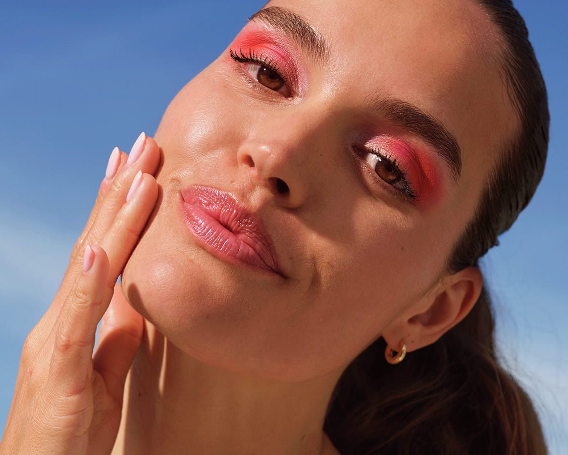 women applying face serum