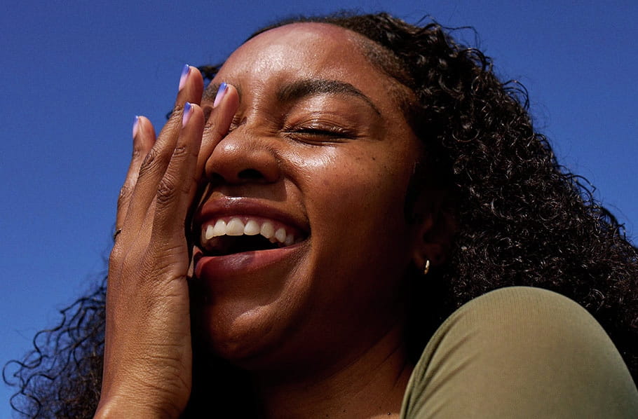 half face covered women smiling