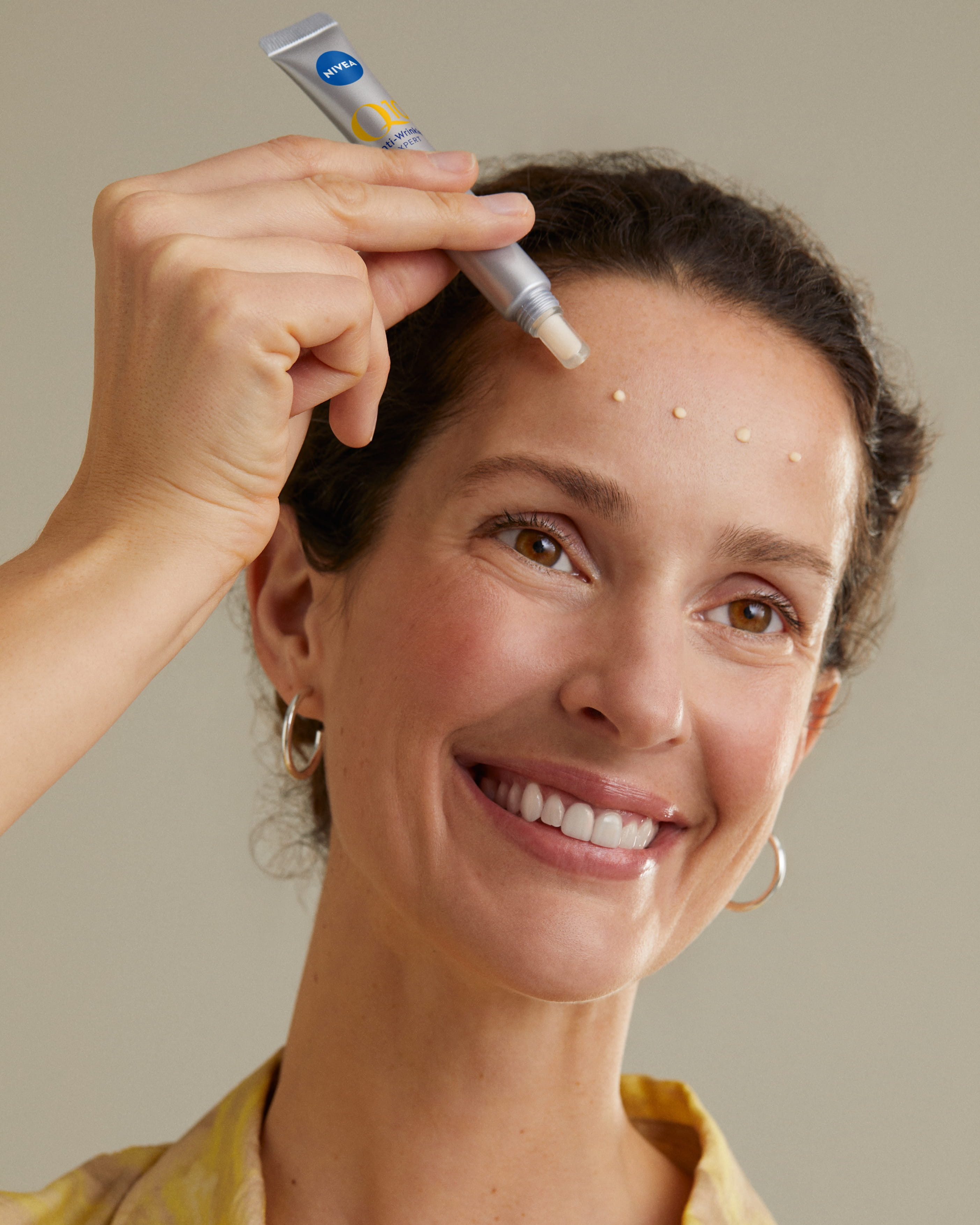 kvinna som applicerar Nivea-serum i ansiktet