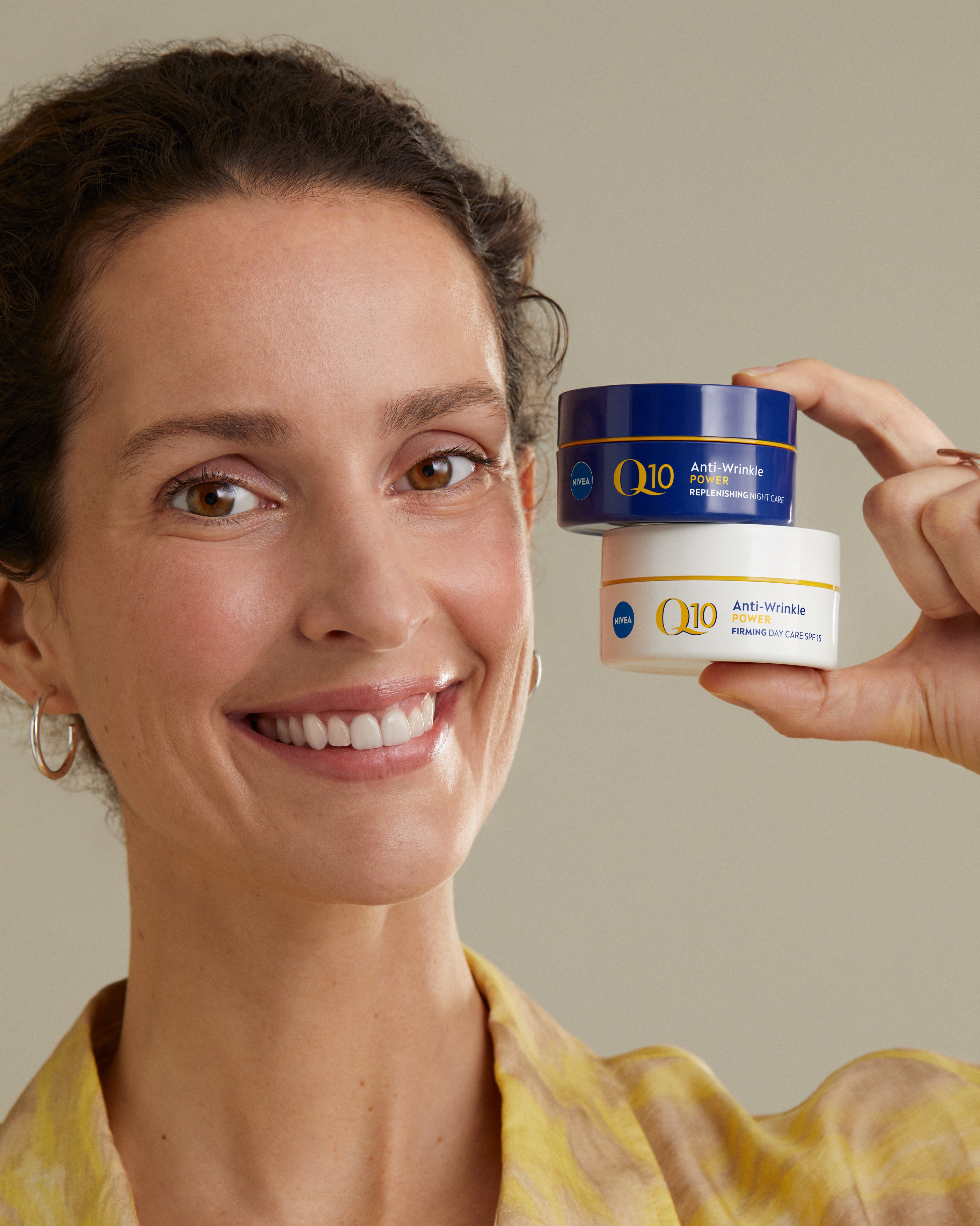 women smiling and showing two NIVEA's Q10 Anti-wrinkle creams