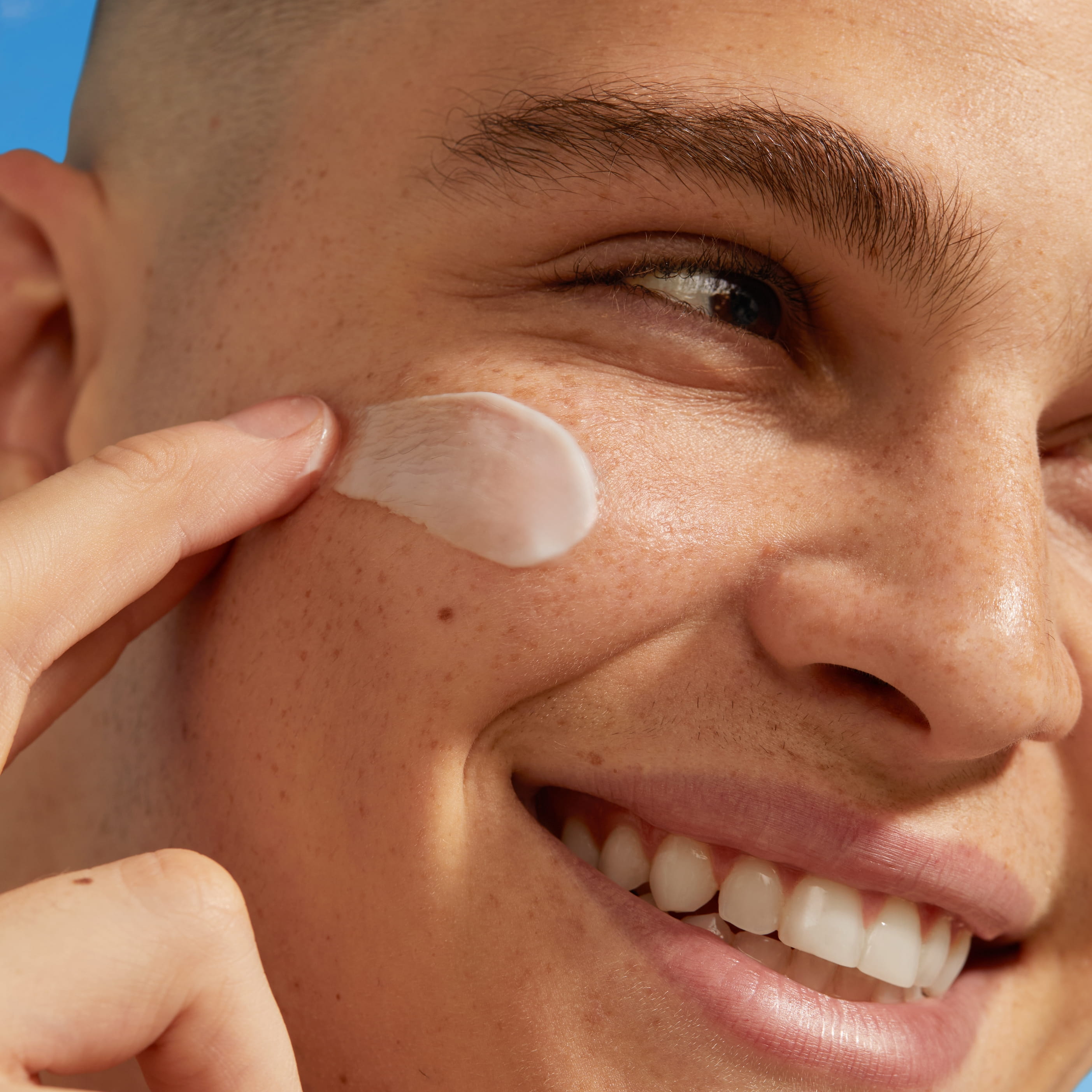 En närbild på ett ansikte som har kräm på kinden