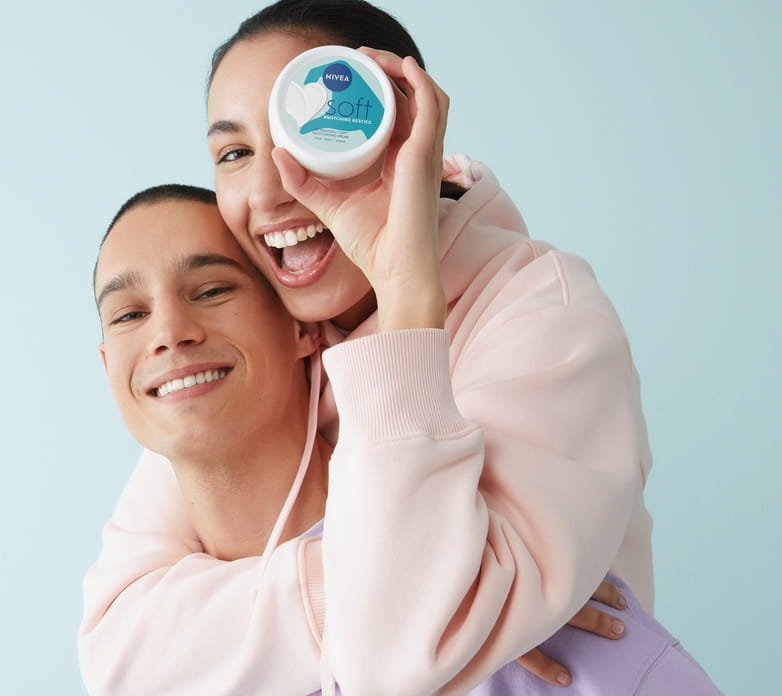 Young couple using NIVEA Soft