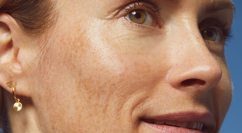 woman holding a Nivea Sun Spot Control Face Cream