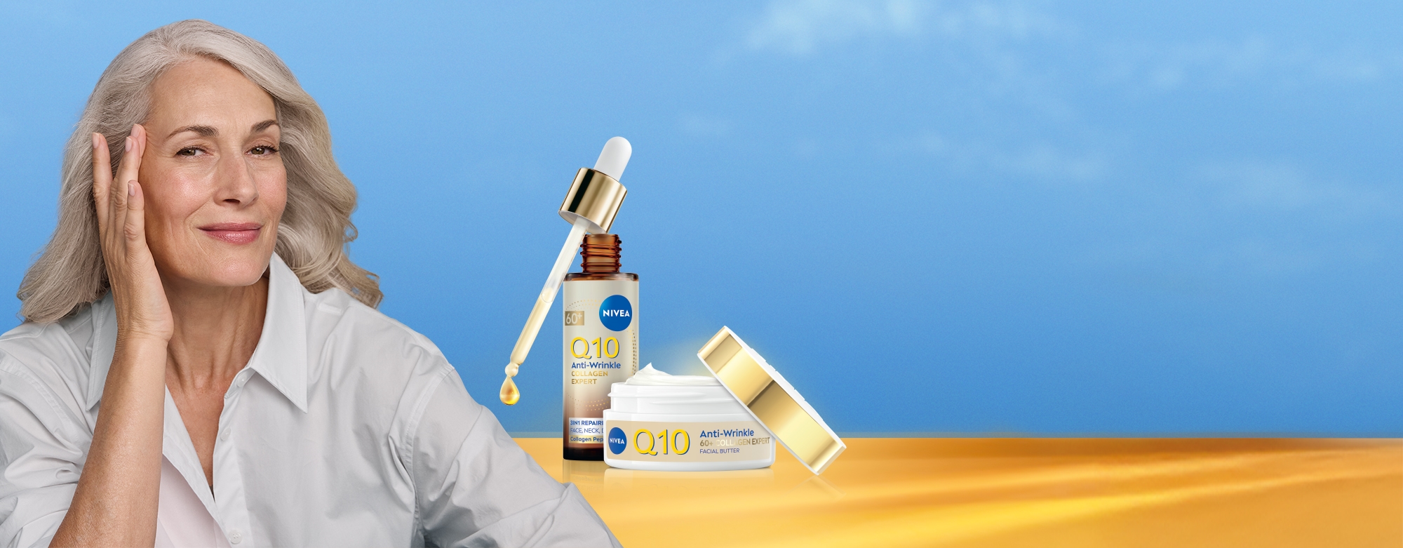 Mature woman gazes, with hand holding up Q10 Anti-Wrinkle Collagen Expert 3in1 Repairing Serum. 