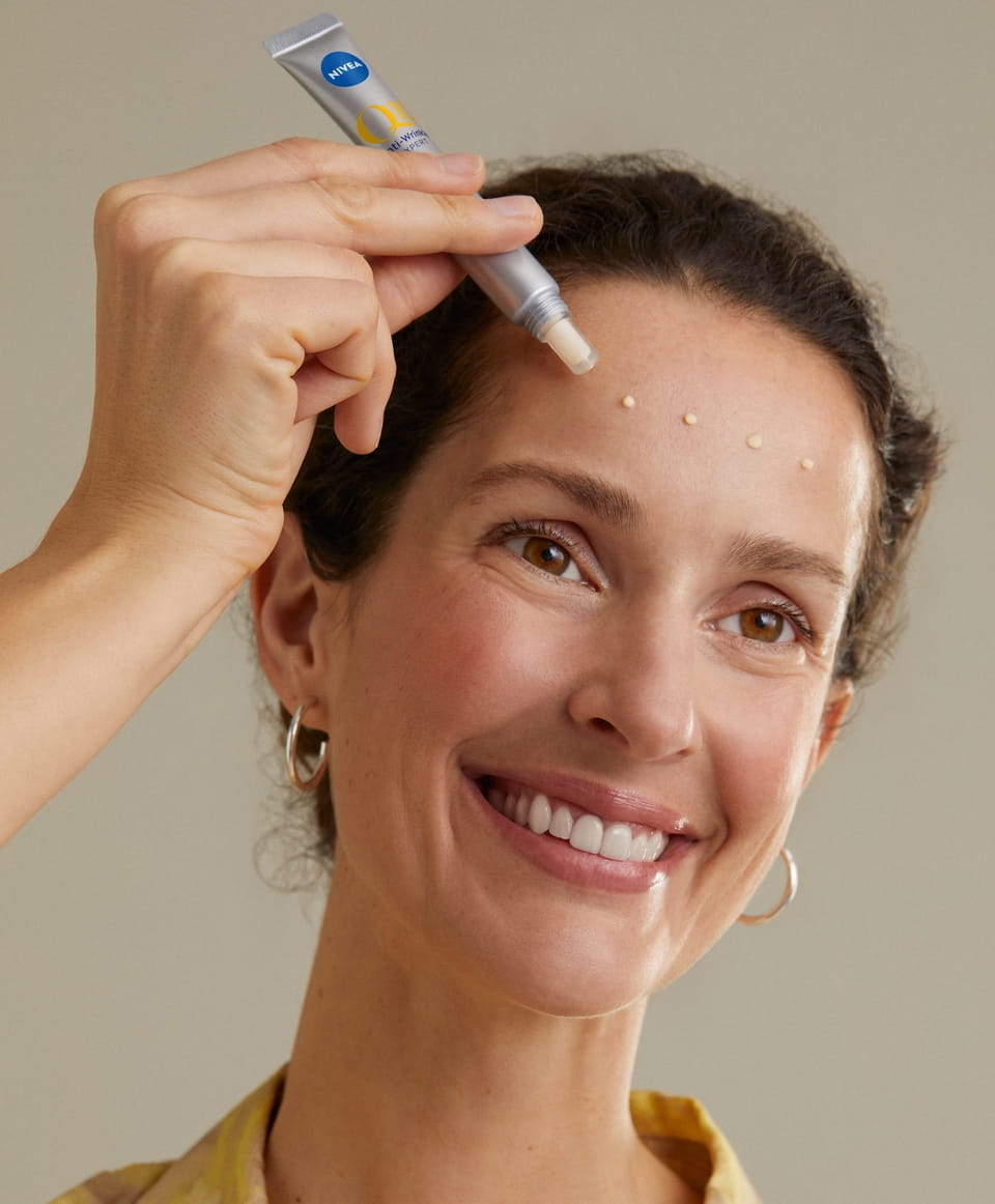 Woman using Q10 Anti-Wrinkle Power Expert Targeted Wrinkle Filler Serum