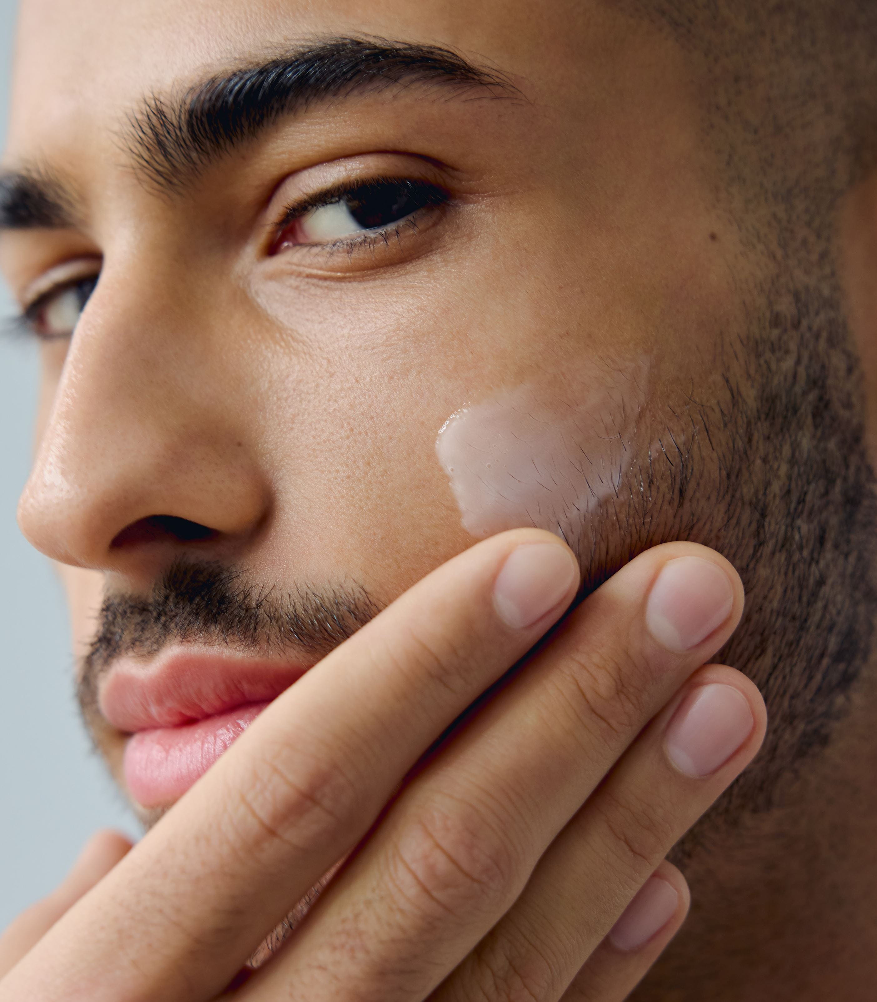 Man applying NIVEA moisturizer