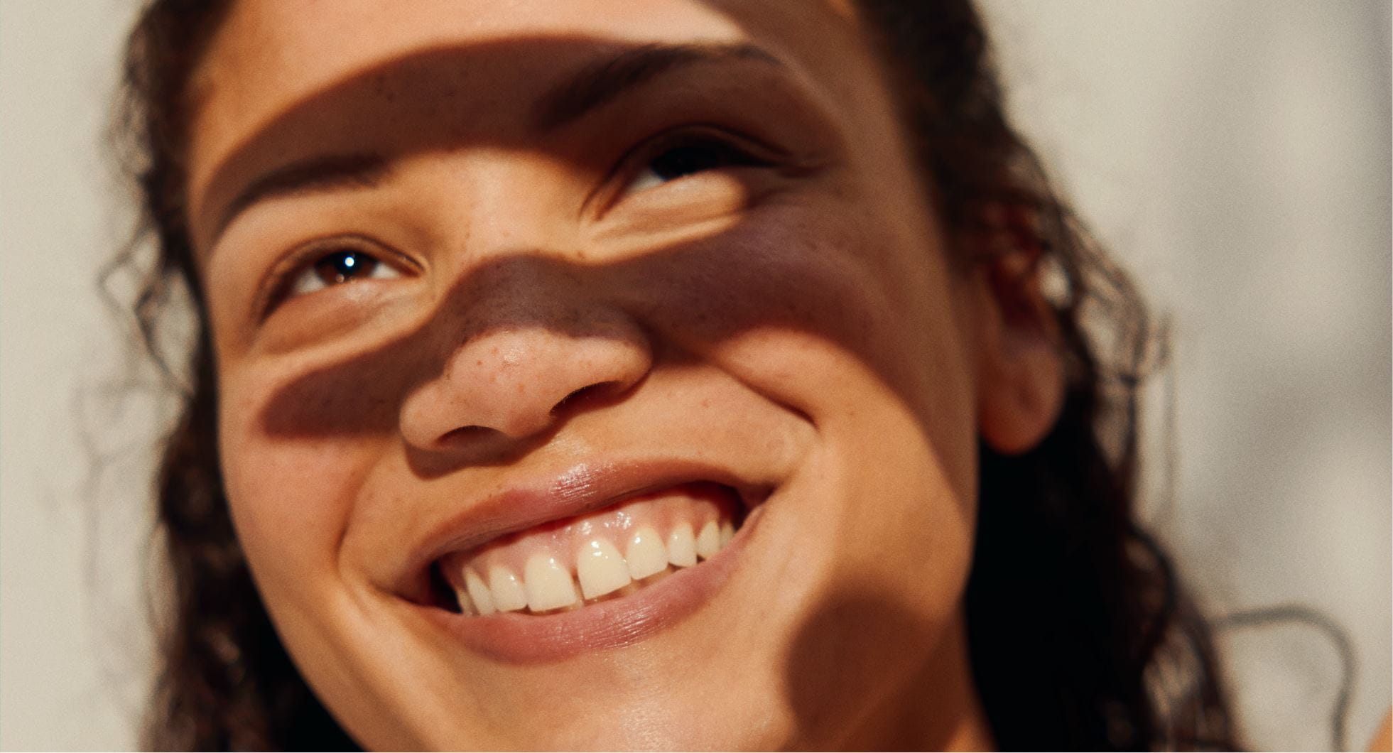 A woman shielding her face from the sunlight