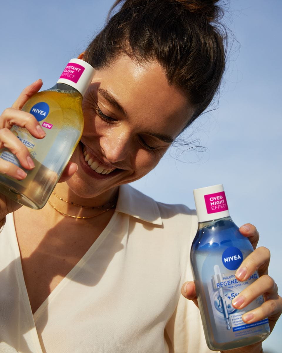 Mujer joven usando aguas infundidas con suero micelar Nivea