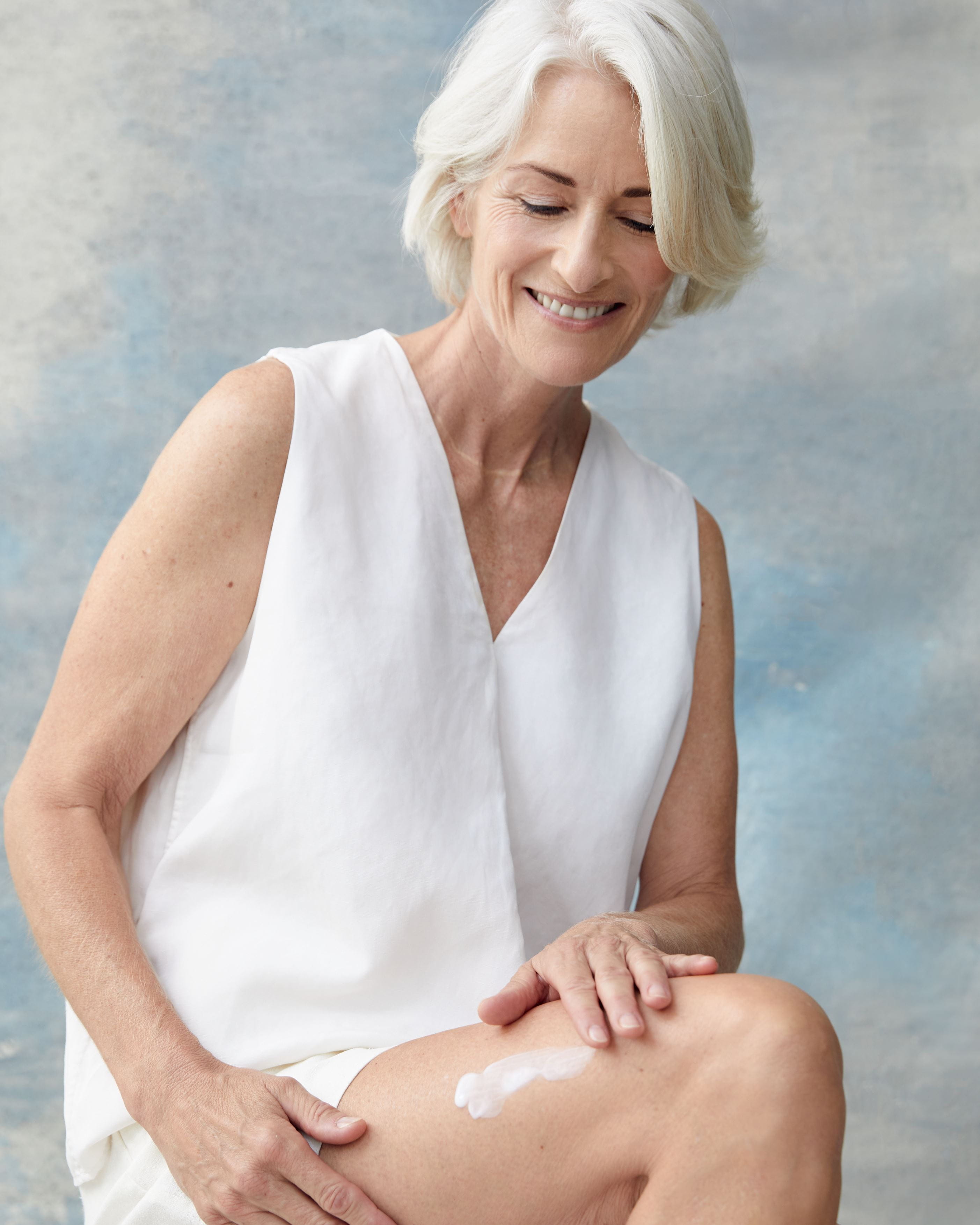woman applying lotion to her leg