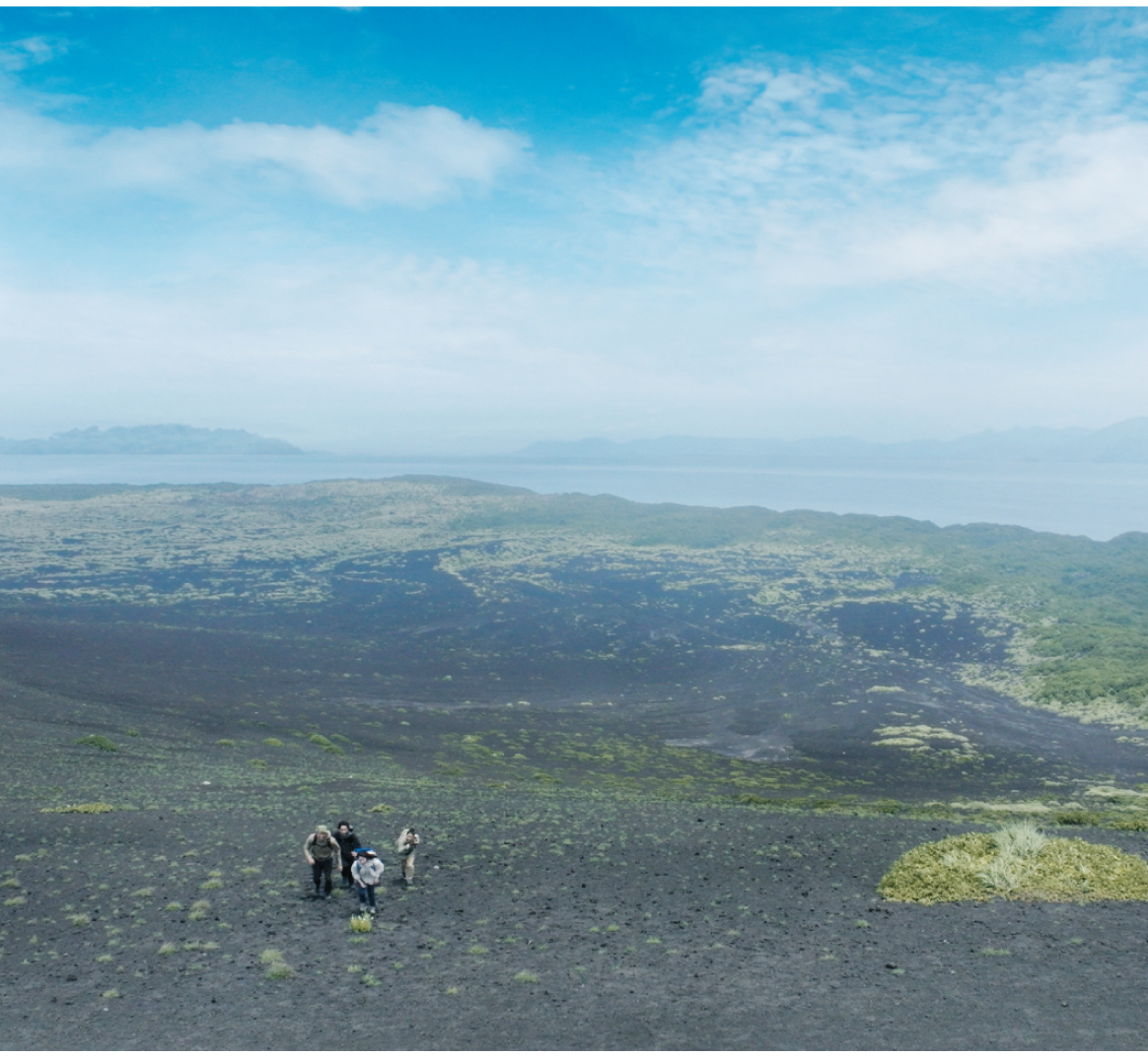 北風が吹く壮大な土地でフィールドワークする男女