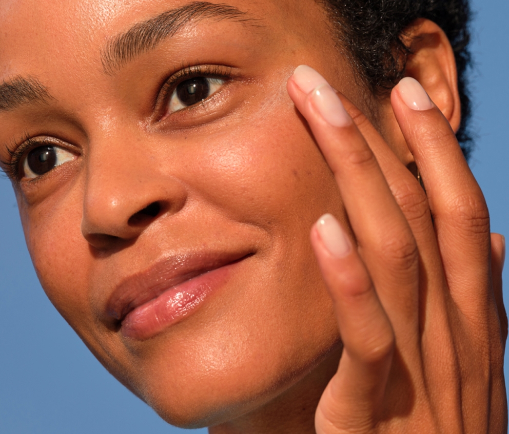 Woman applying skincare cream to her face