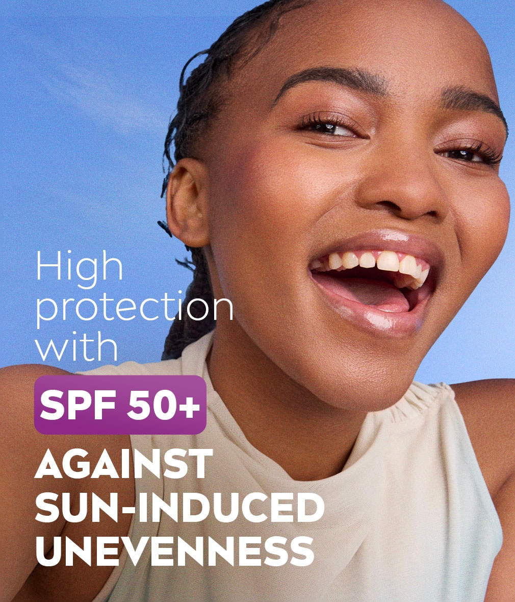 Young woman laughing widely, showing the glowing skin complexion, with text about high protection.
