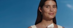 Young woman applies the new NIVEA SUN Breathable UV Specialist Silky UV Stick SPF 50+ to her cheek, basks in the light.