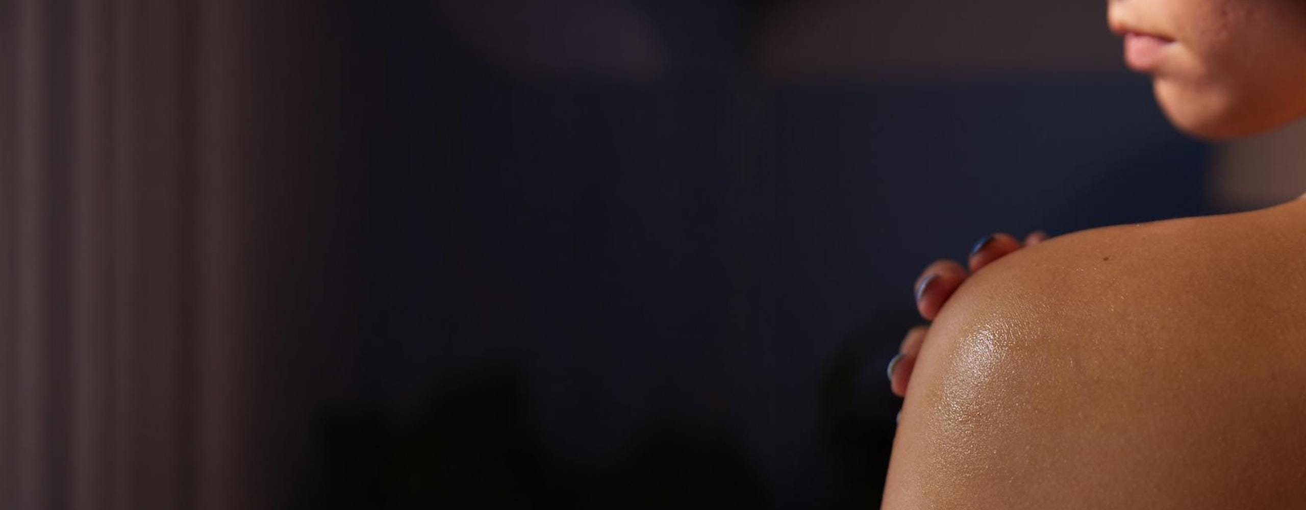 curly hair girl holding a Nivea face cream