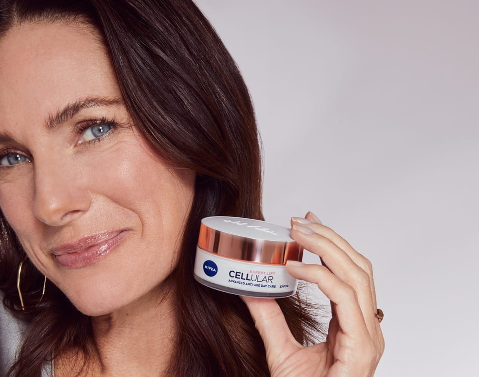 Woman using NIVEA Cellular Expert Lift Filler Day Cream