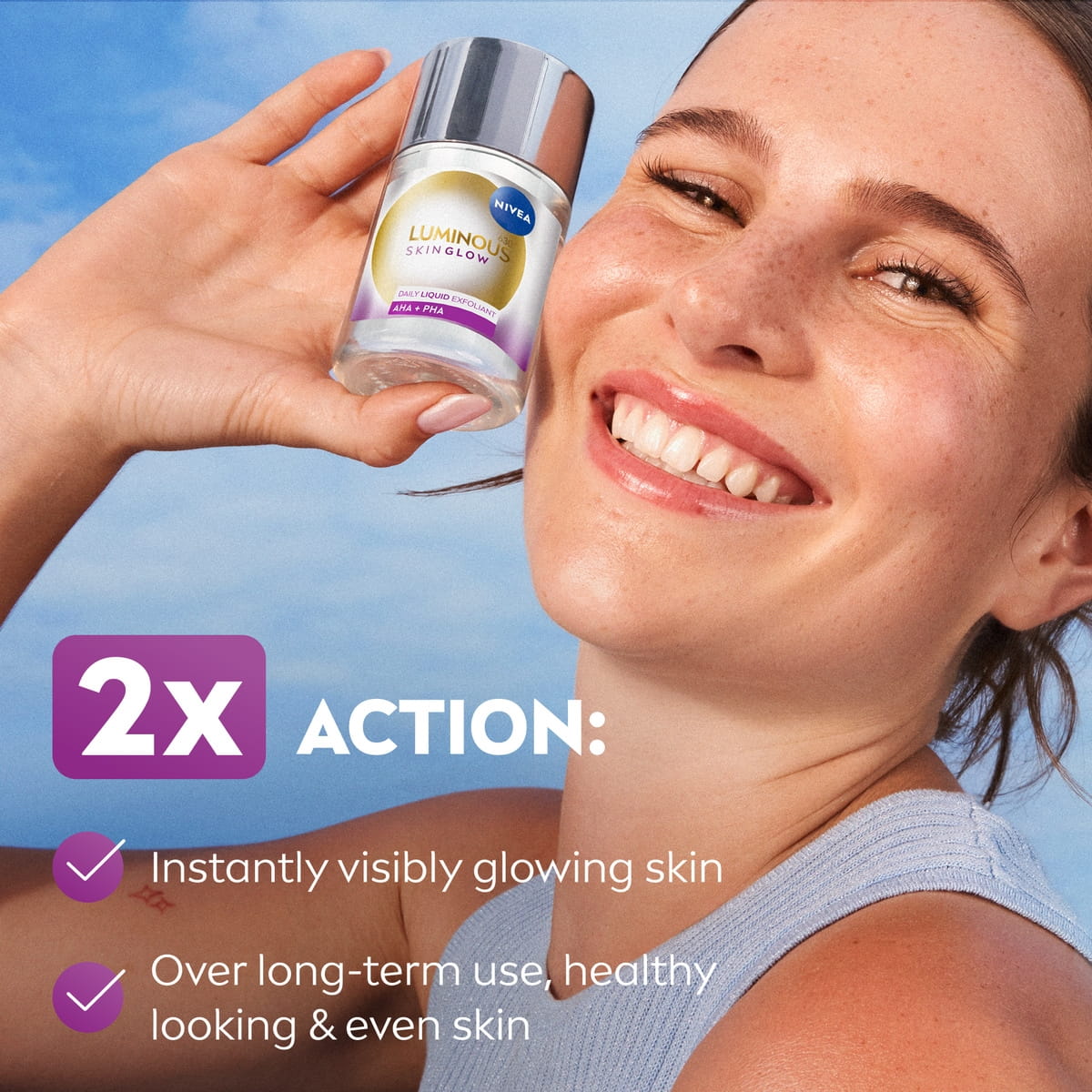 A young woman glowing complexion smiles gleefully while holding up a bottle of NIVEA LUMINOUS630® Skin Glow Liquid Refiner.