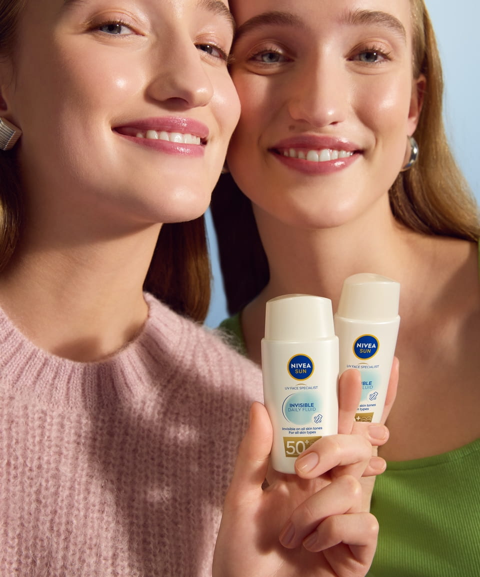 girl applying Nivea sun protection spray