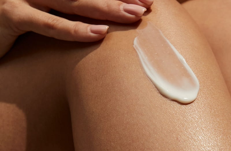 mother and daughter applying sun cream