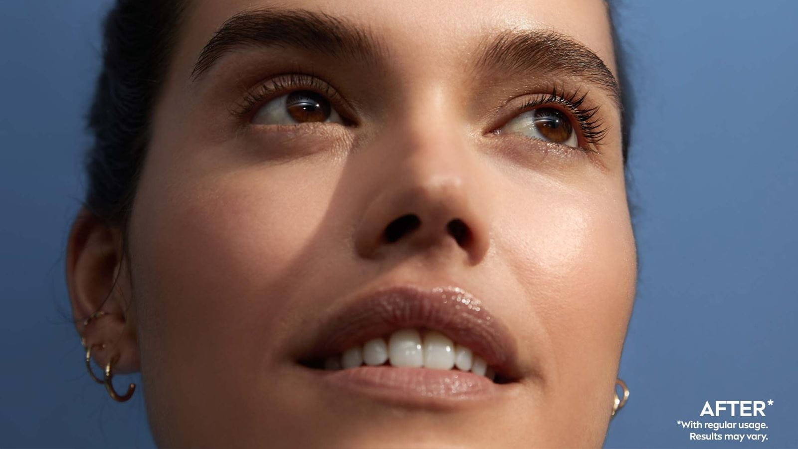 A close-up of a woman's face split down the middle, showing a "Before" on the left and an "After" on the right. The left side looks less radiant, while the right side appears more glowing and smooth. The background is a soft blue.