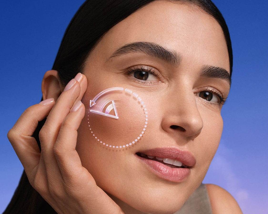 A woman touches her cheekbone area, with a reversing time icon featured over her face.