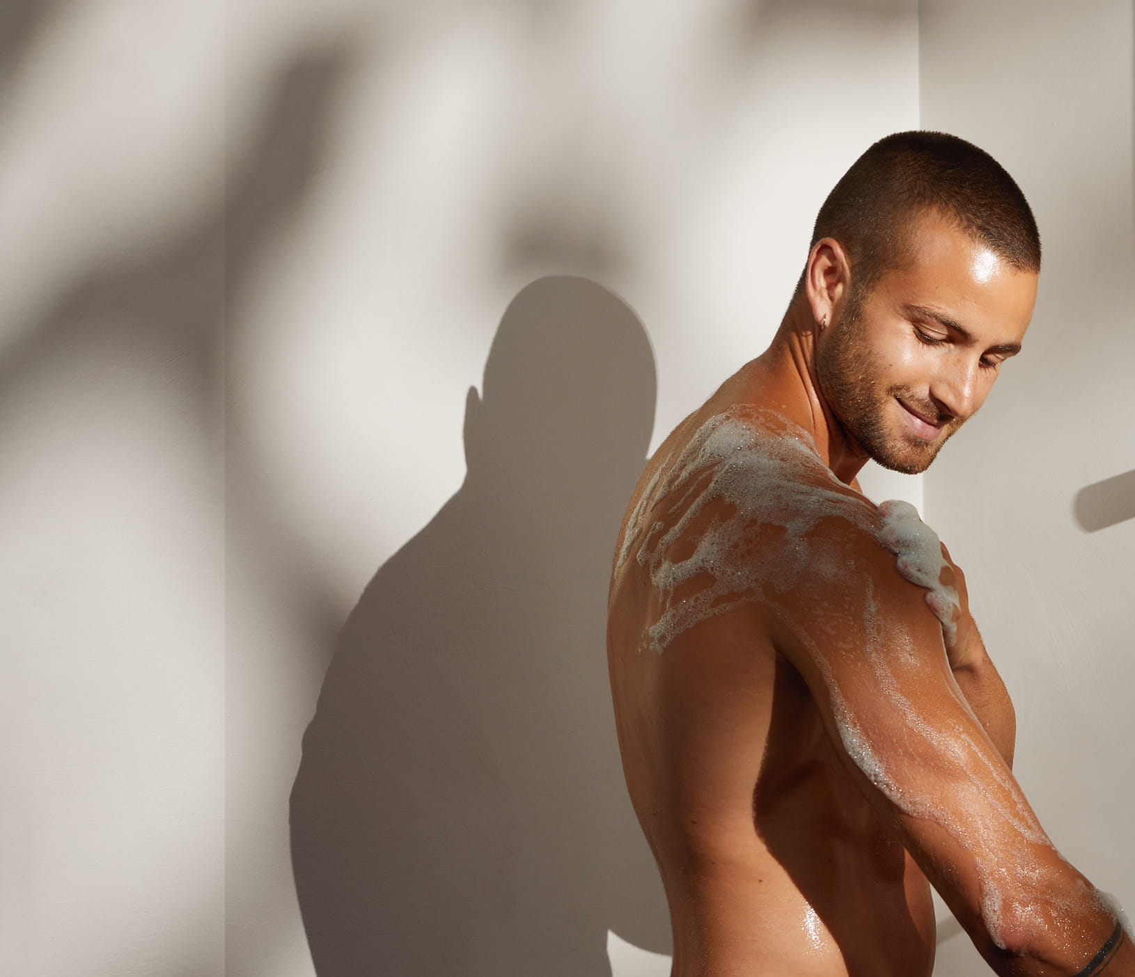 Young man having a shower