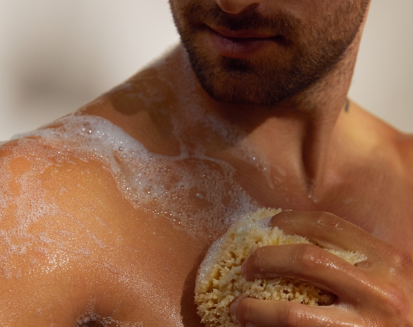 Young man having a shower