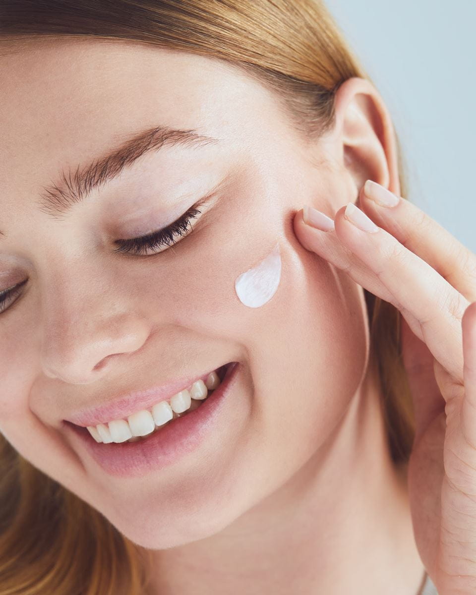 woman applying Nivea serum on her face