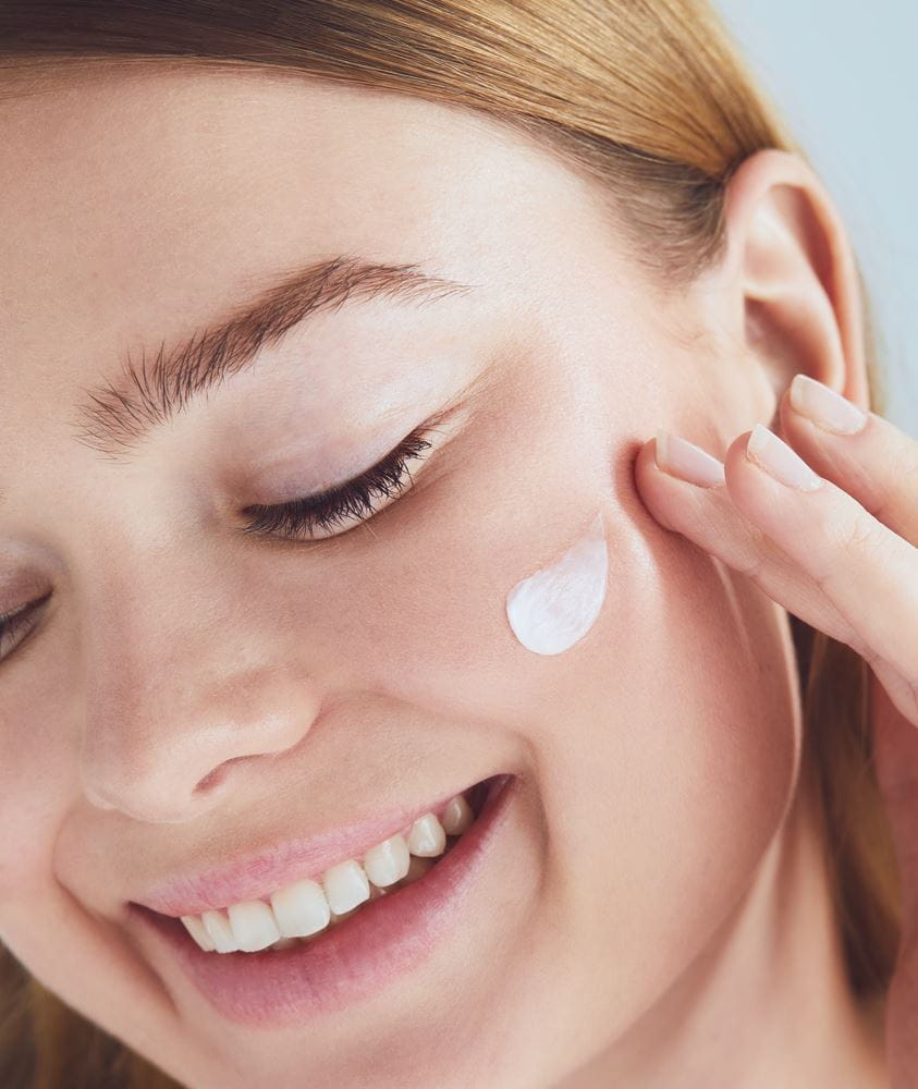 woman applying Nivea serum on her face