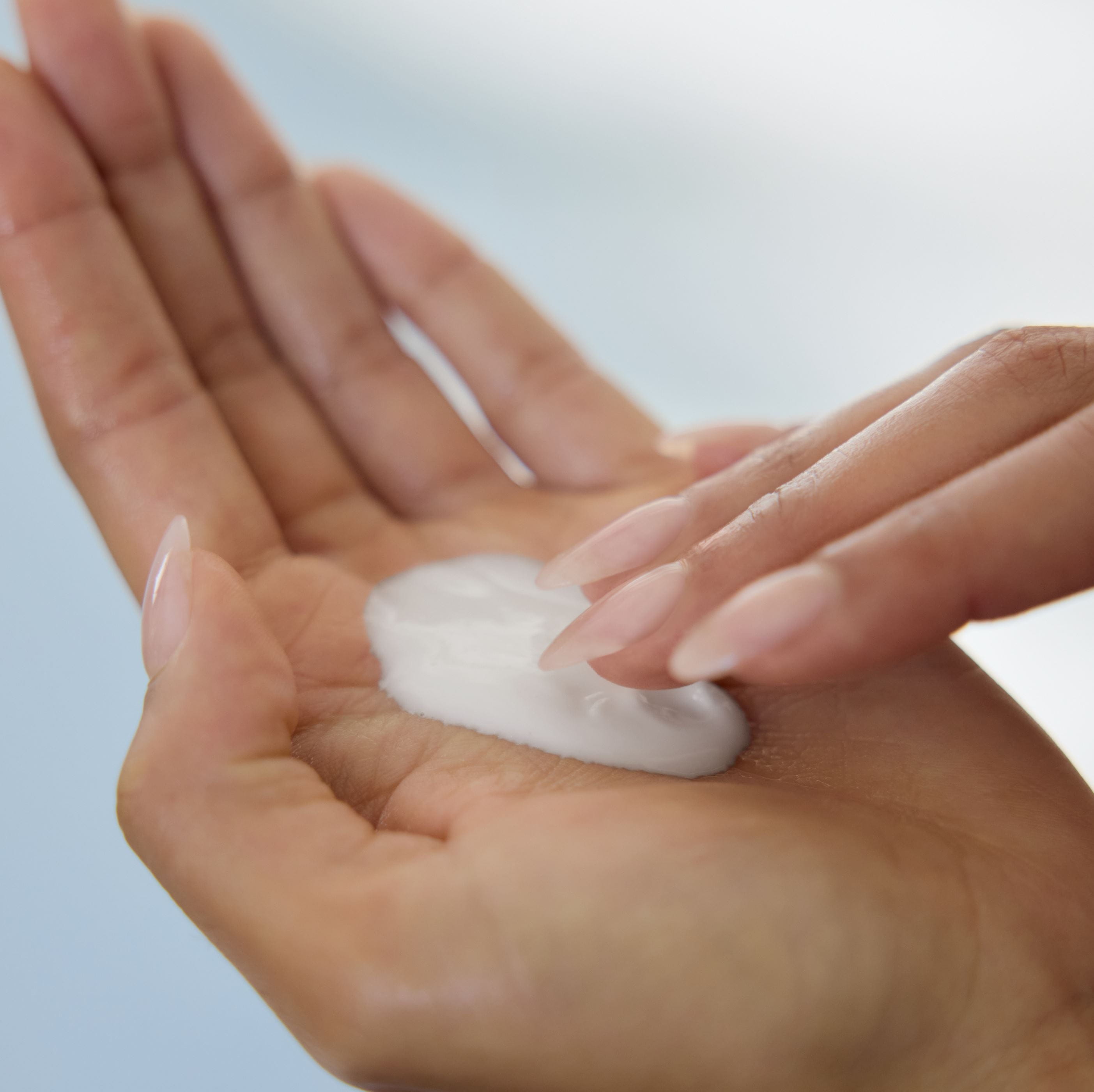 hand-in-cream-jar-smiling-woman
