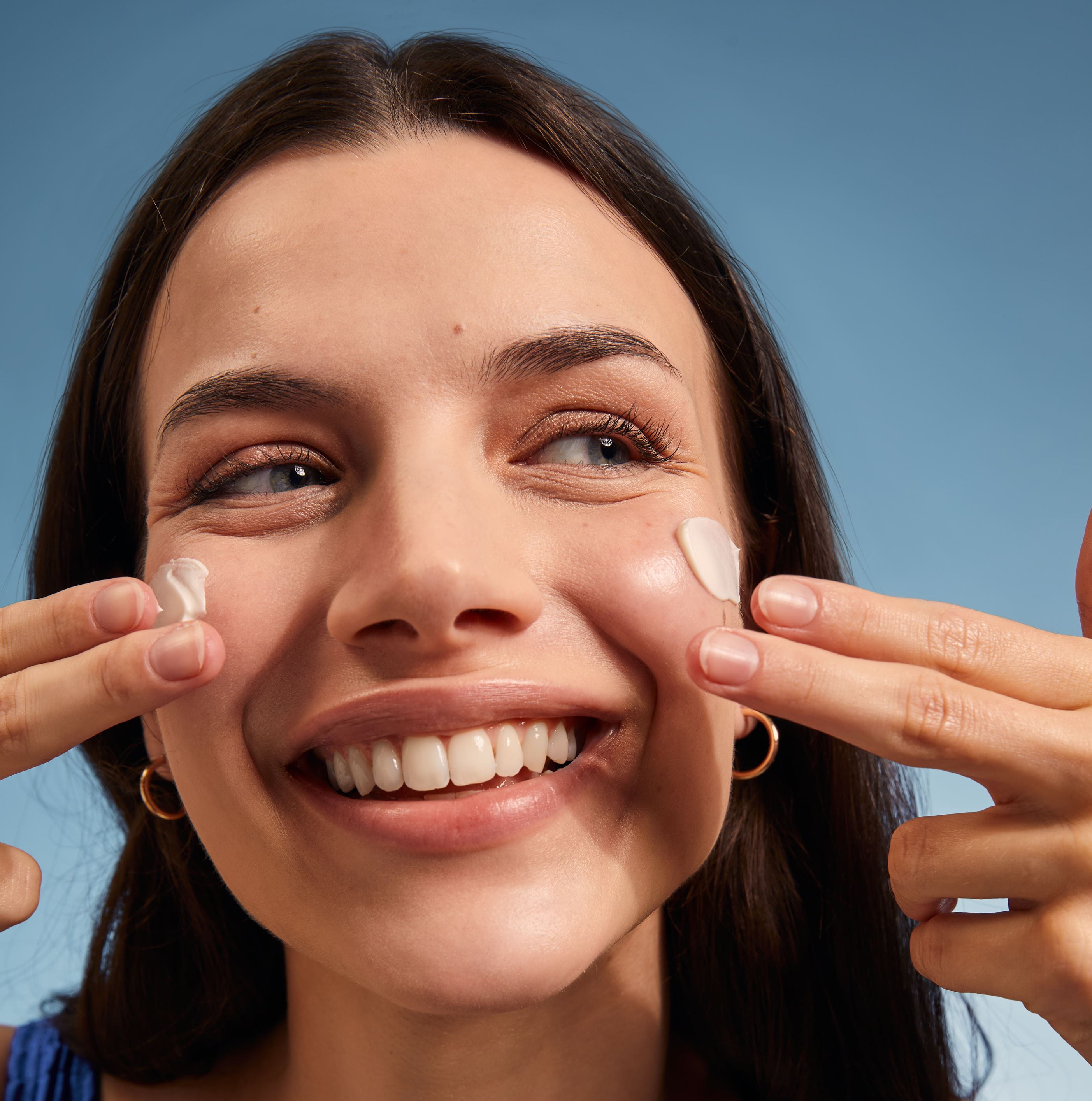 woman smiling with Coppertone sunscreen on her face