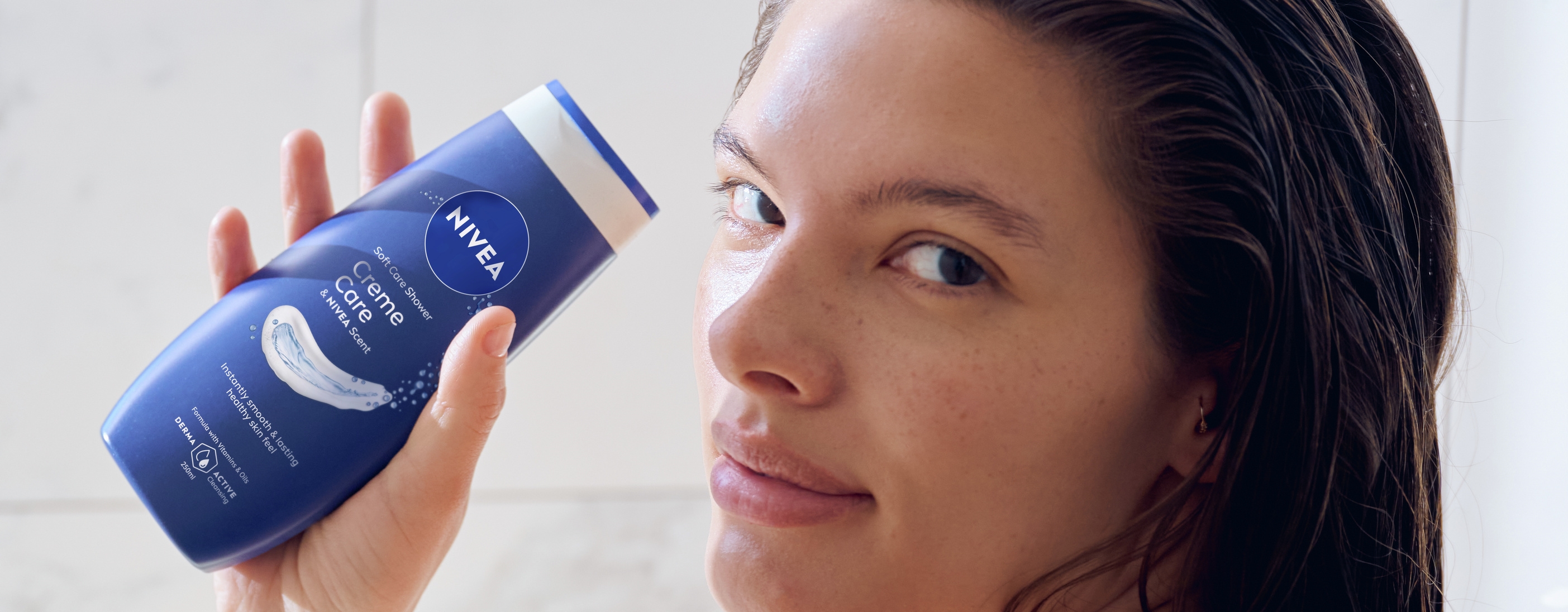 Young woman using Nivea Creme Care Soft Care Shower