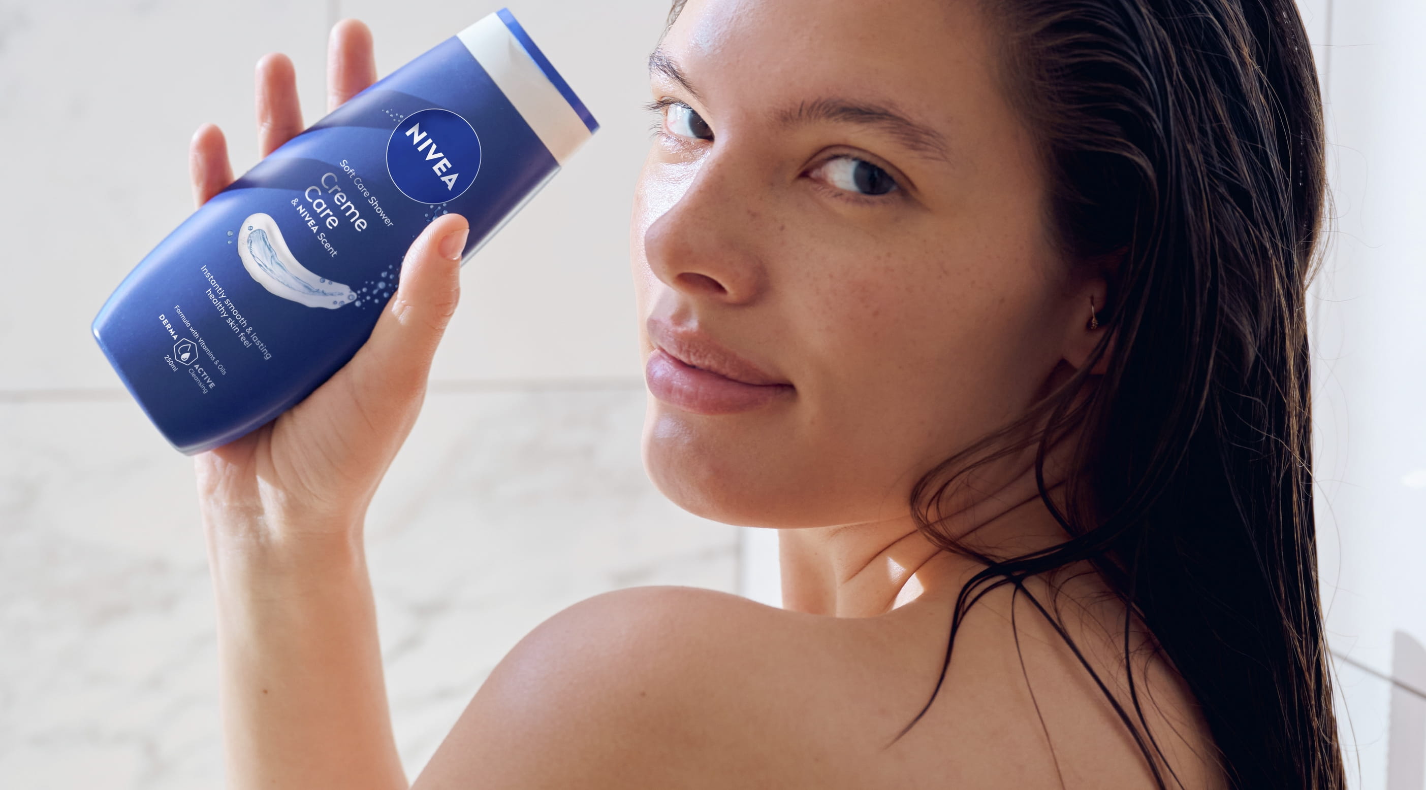 Young woman using Nivea Creme Care Soft Care Shower