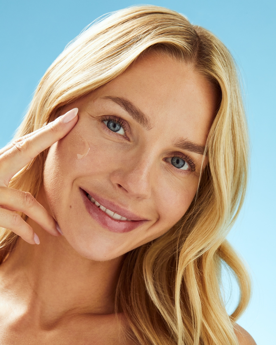 women applying sunscreen on her face