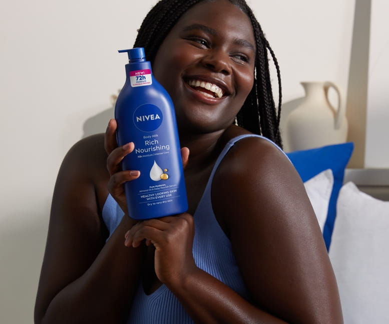 Young woman using Rich Nourishing Body Lotion Dry Skin