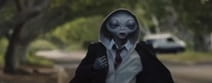 Alien walking in a residential background turning around to greet a girl