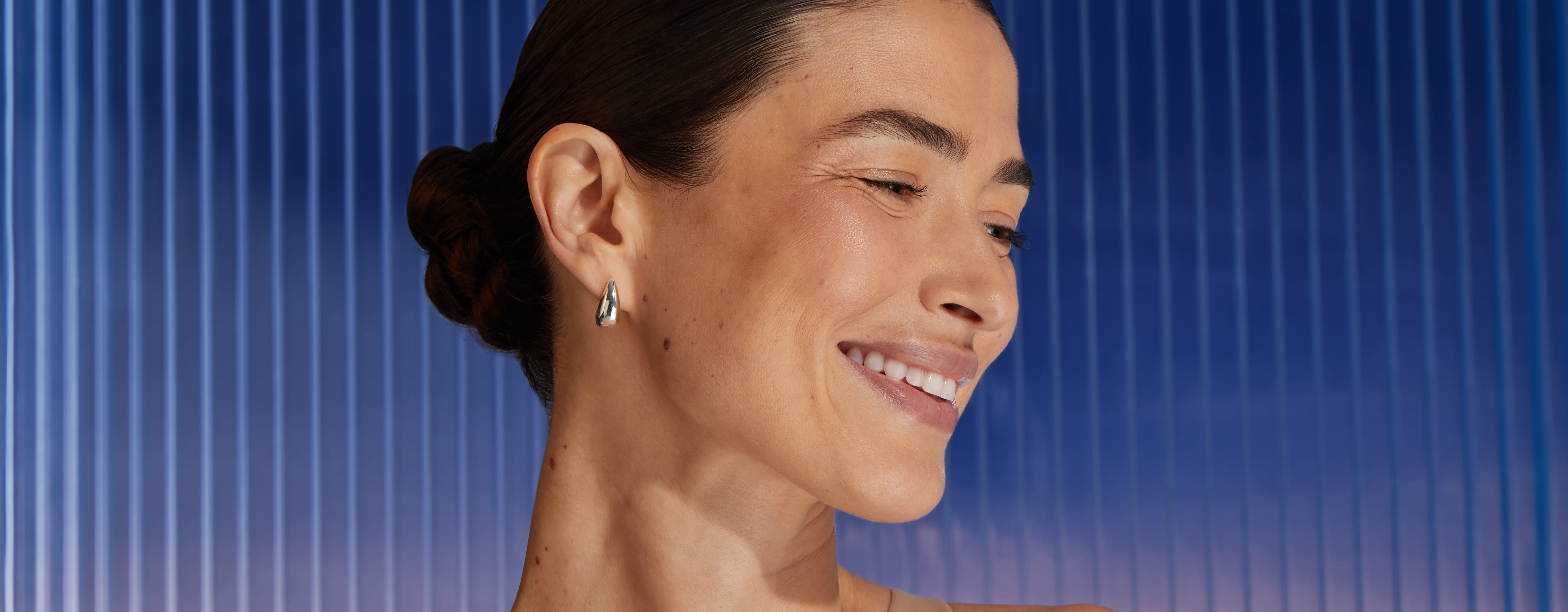 Young woman smiling with a purple background