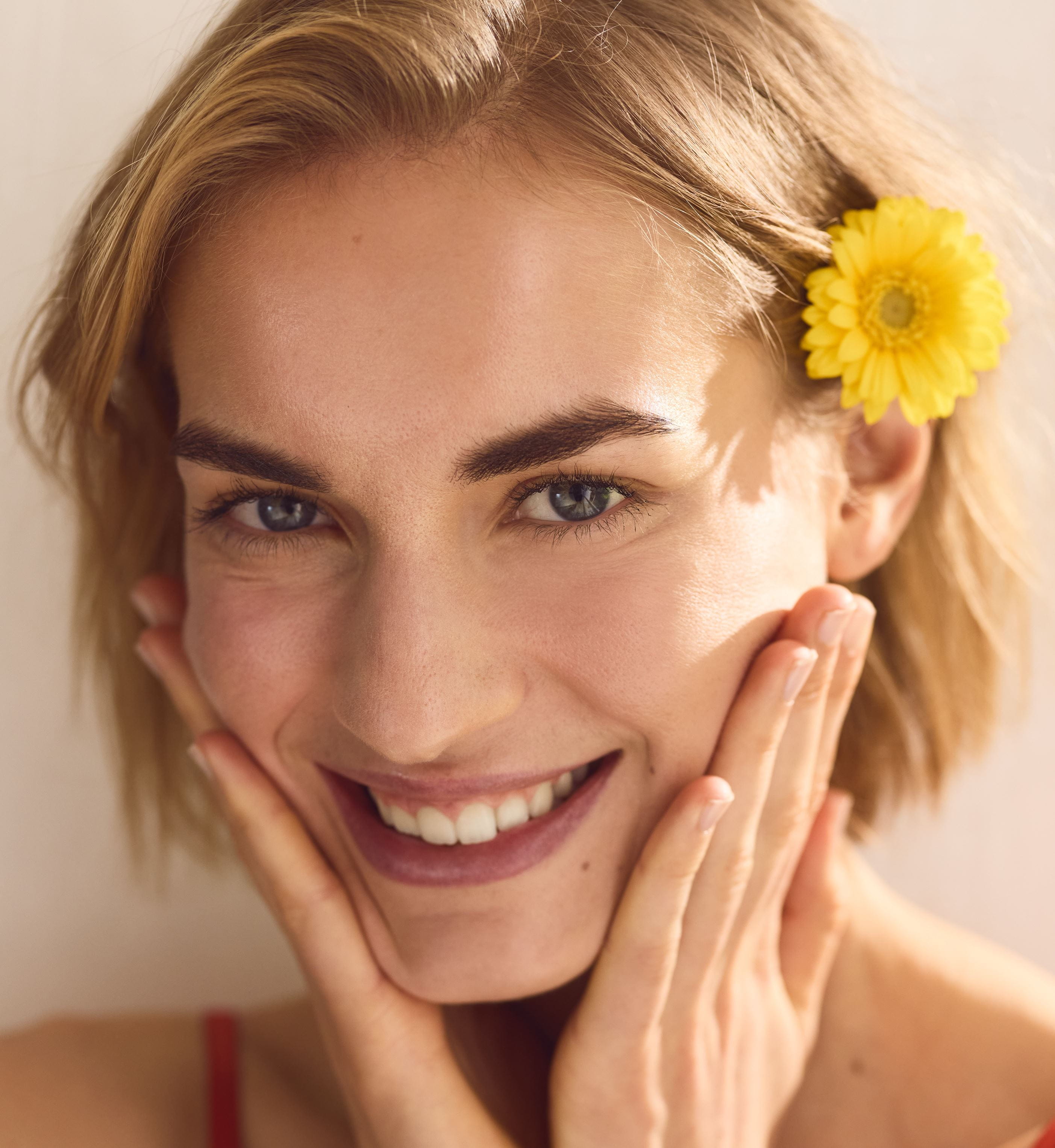 usmívající se dáma s květinou ve vlasech