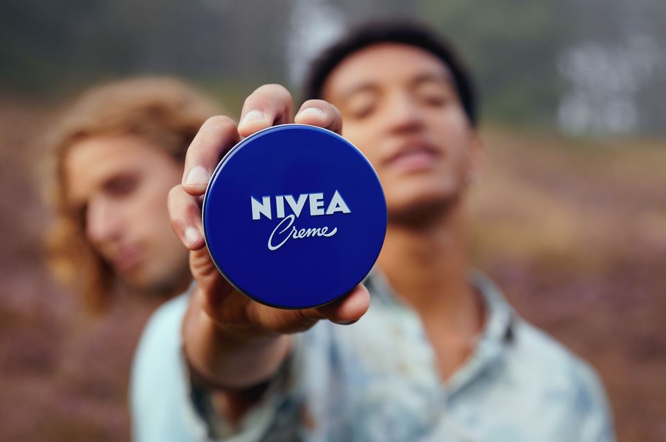 homem a segurar uma lata NIVEA Creme