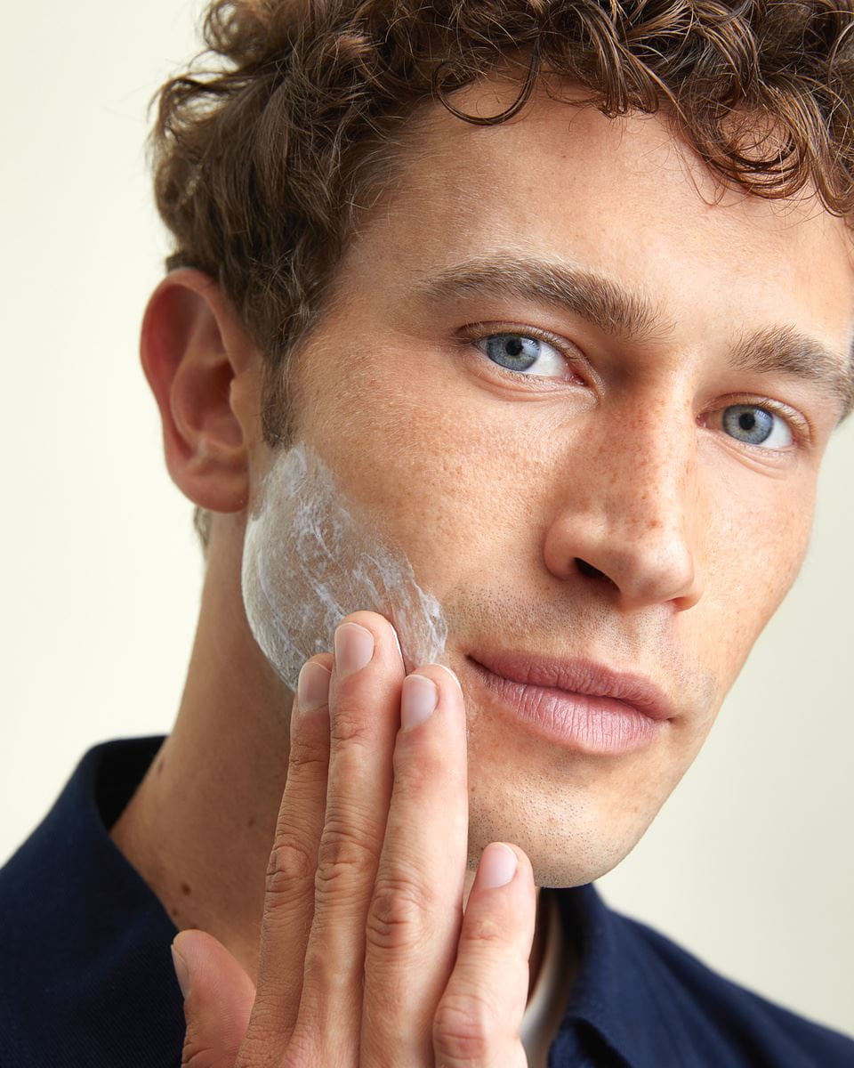 young man using Nivea face cream