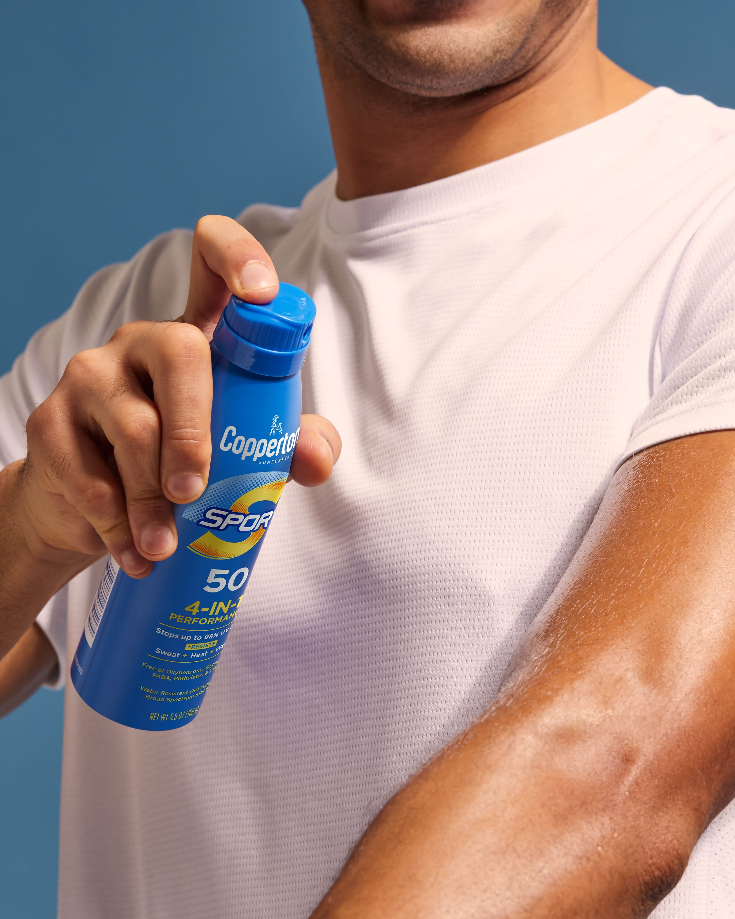 man applying coppertone sunscreen
