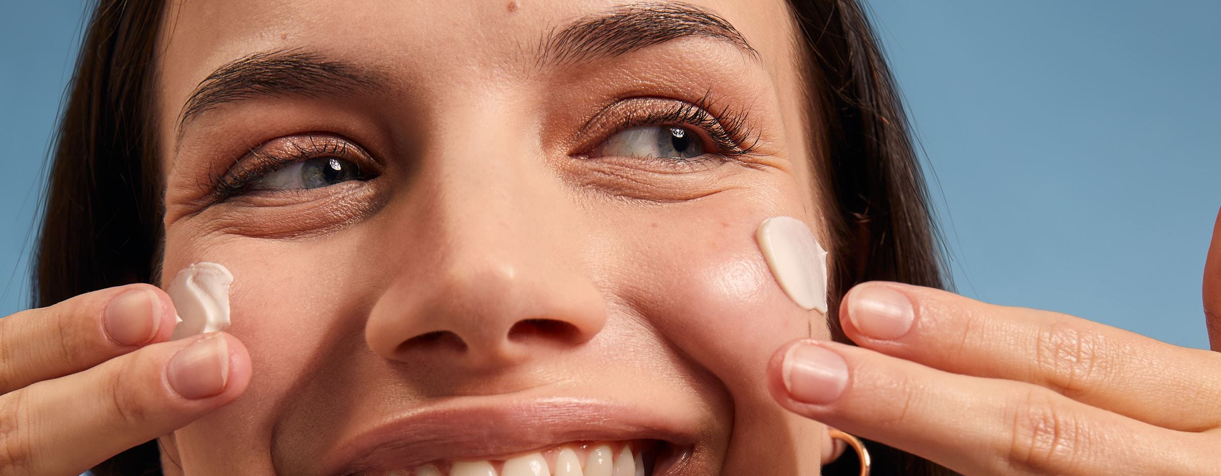 woman applying sunscreen on her face