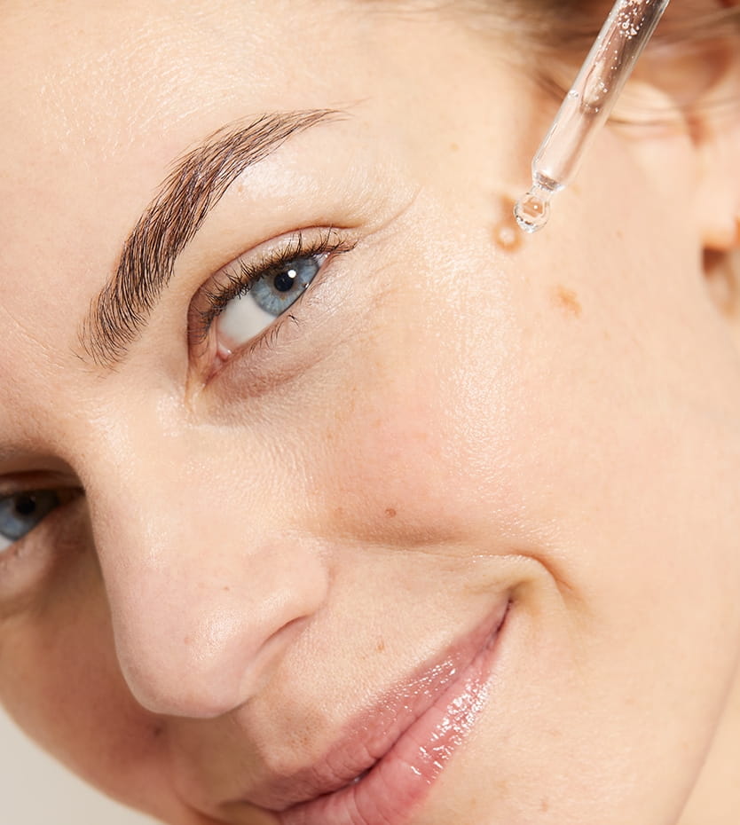 Young women applying serum