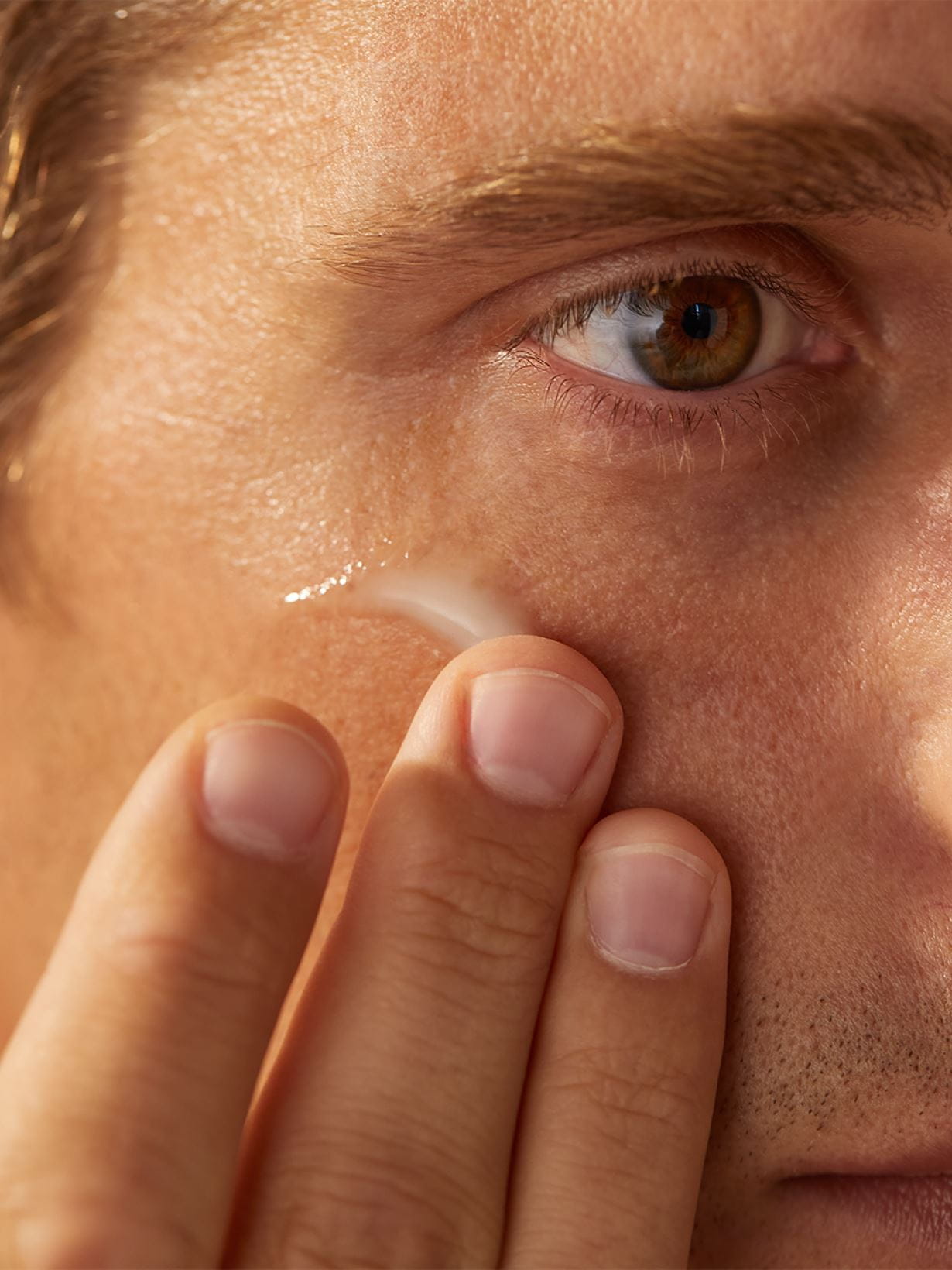 Man applying eye cream