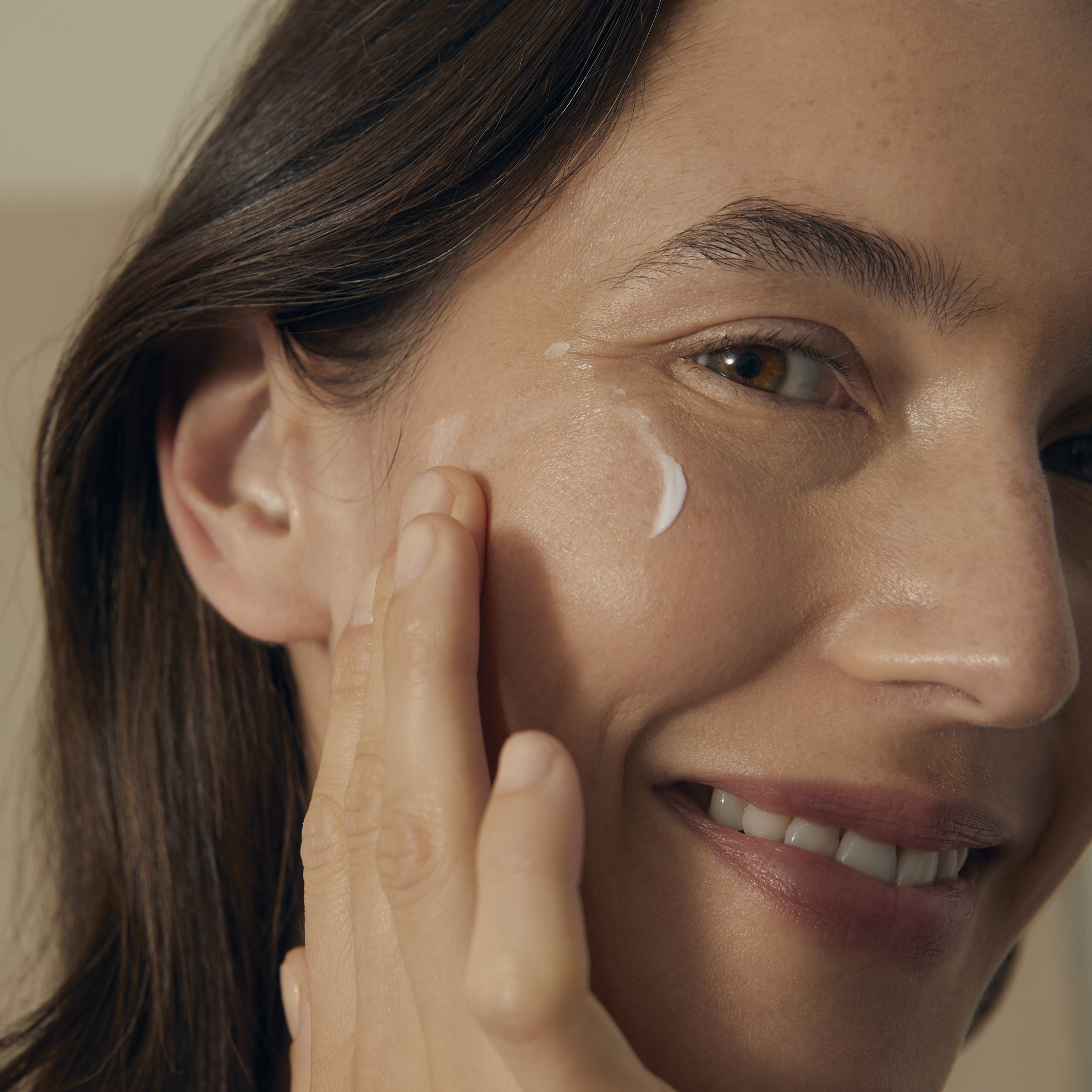 woman holding a Nivea Q10 face cream