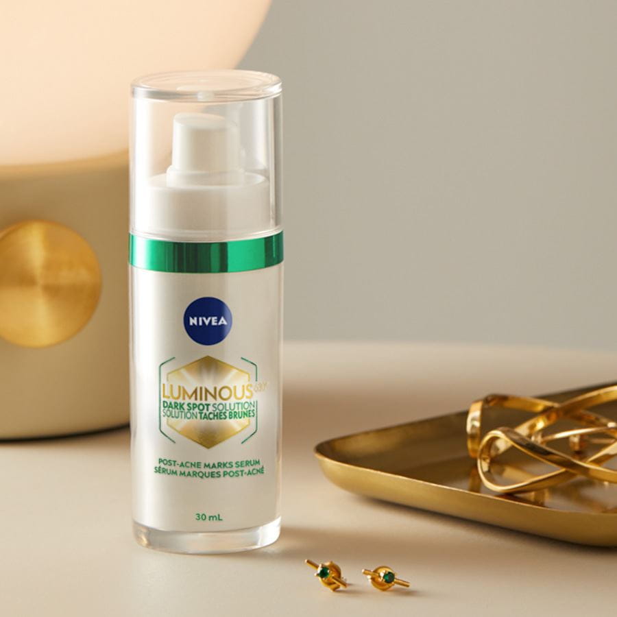  An in-focus shot of a 30 ml bottle of Nivea Luminous 630 Dark Spot Solution Post-Acne-Marks Serum on a table.