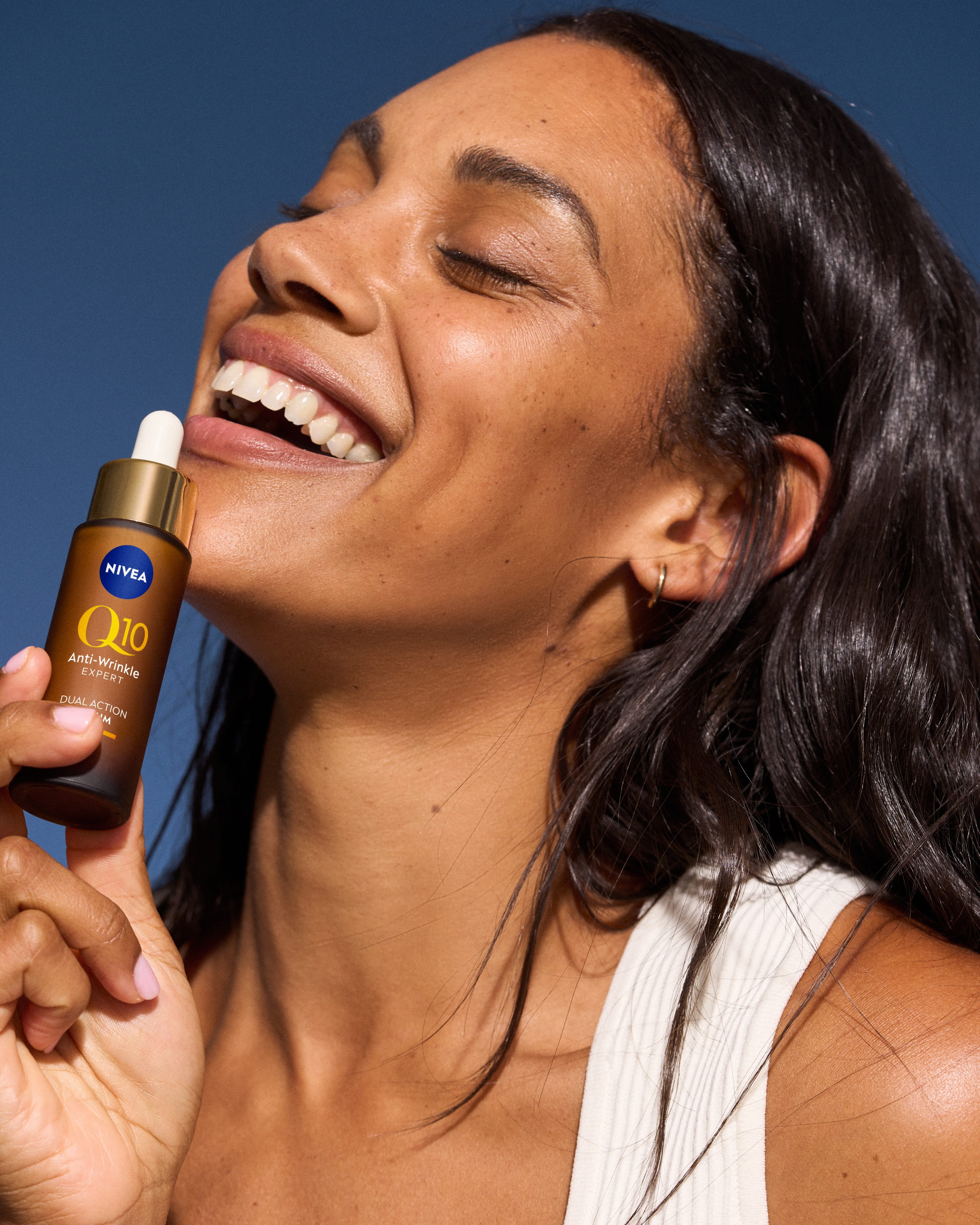 women holding NIVEA's Q10 serum