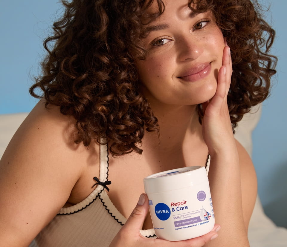 Young woman using NIVEA Repair & Care 15% GLYCERIN + UREA