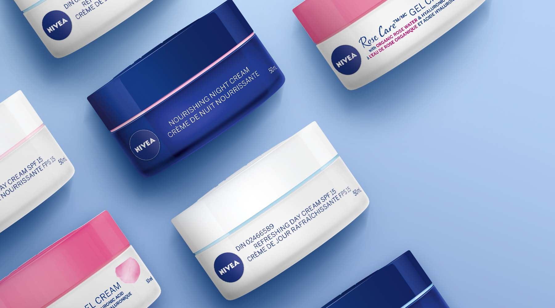 A view of seven NIVEA products placed close to one another against a blue coloured background.