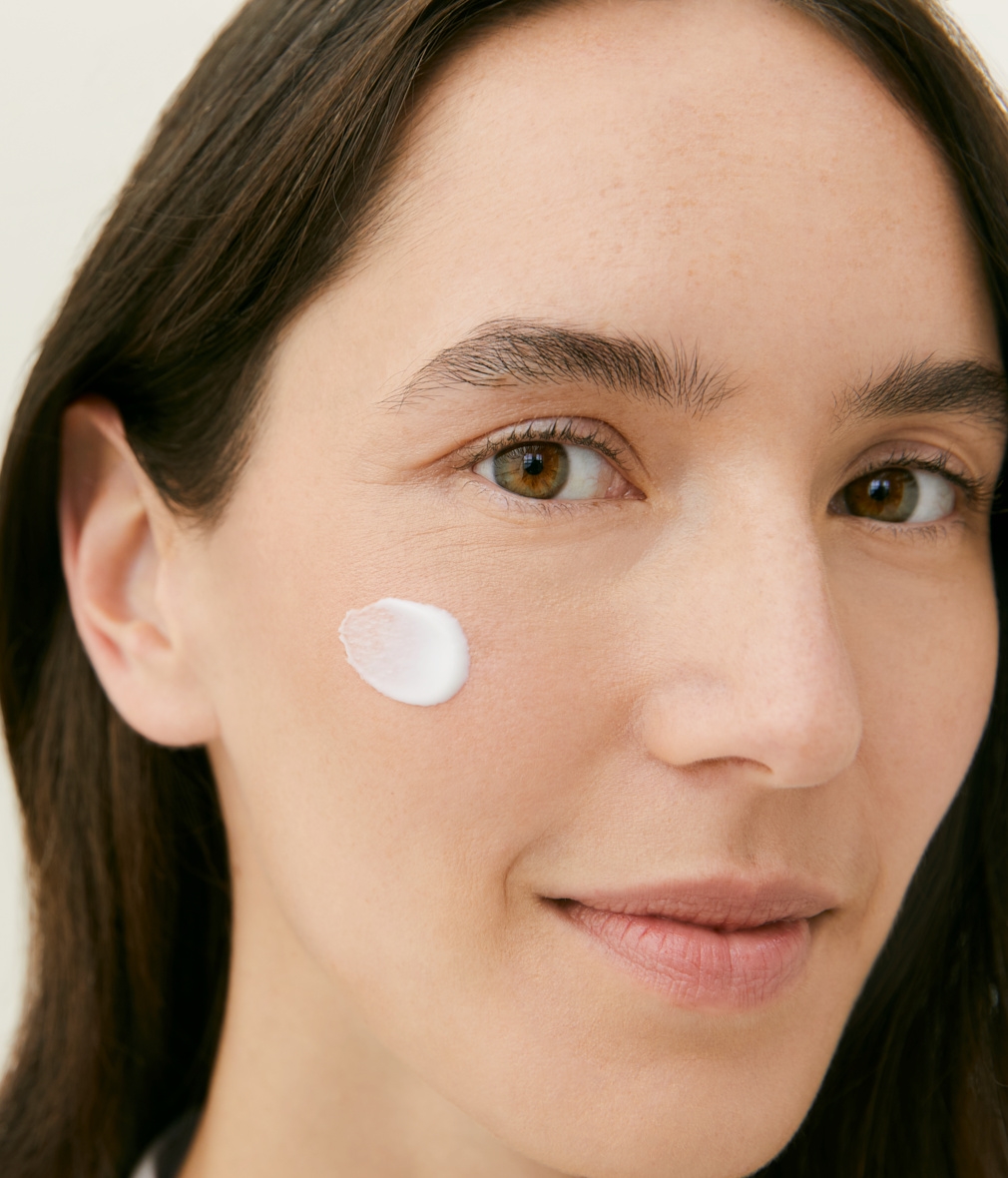 woman with day cream on her face